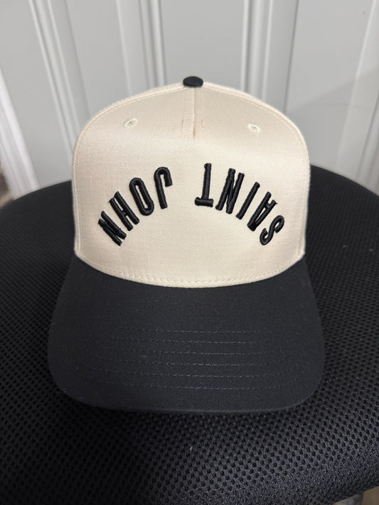Black and beige cap with text on a chair